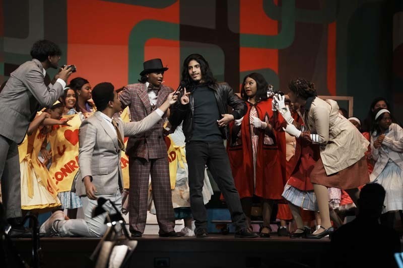 Students dressed in costume performing.