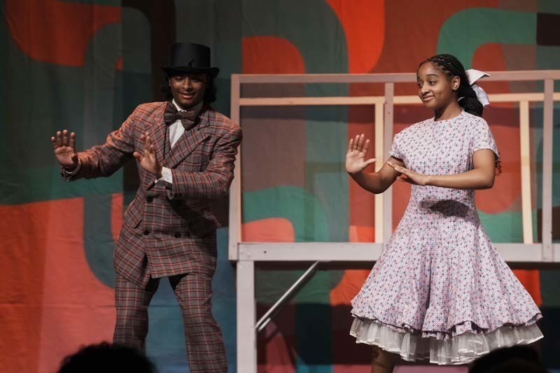 Students dressed in costume performing.