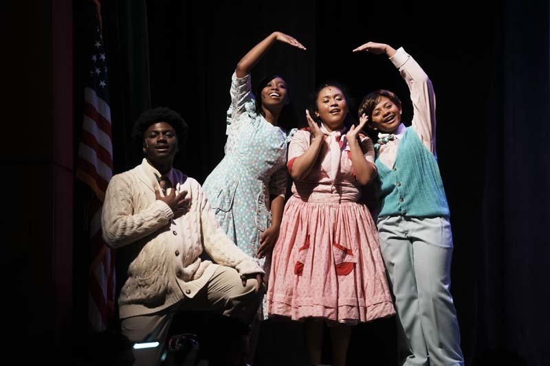 Students dressed in costume performing.