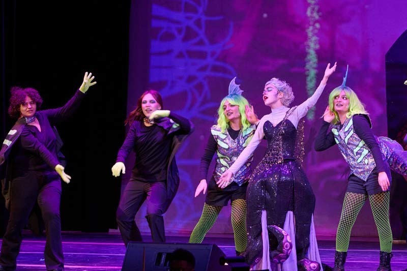 Students performing in costume.