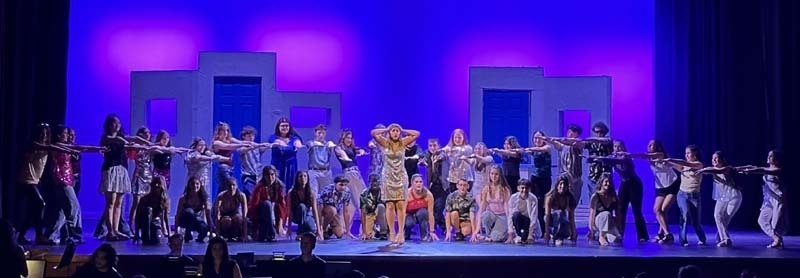 Students performing on stage.