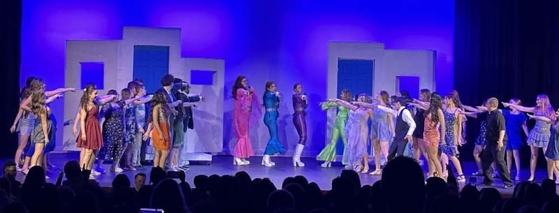 Students performing on stage.