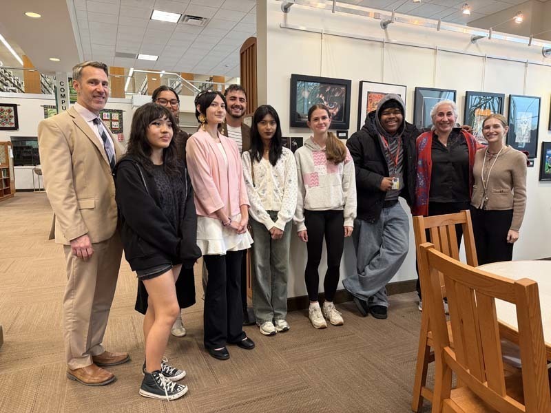 Student-artists smiling together with ar teacher.