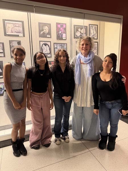 Students and teachers in front of showcase.