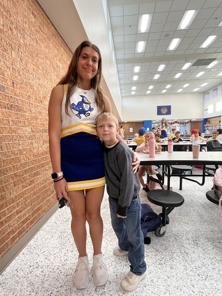 Big smiles as cheerleaders and students start their day.