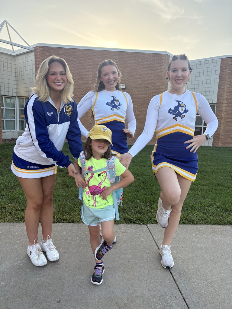 Cheerleaders and student showing off their balance skills.