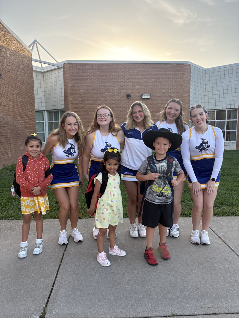 Big smiles as cheerleaders and students start their day.