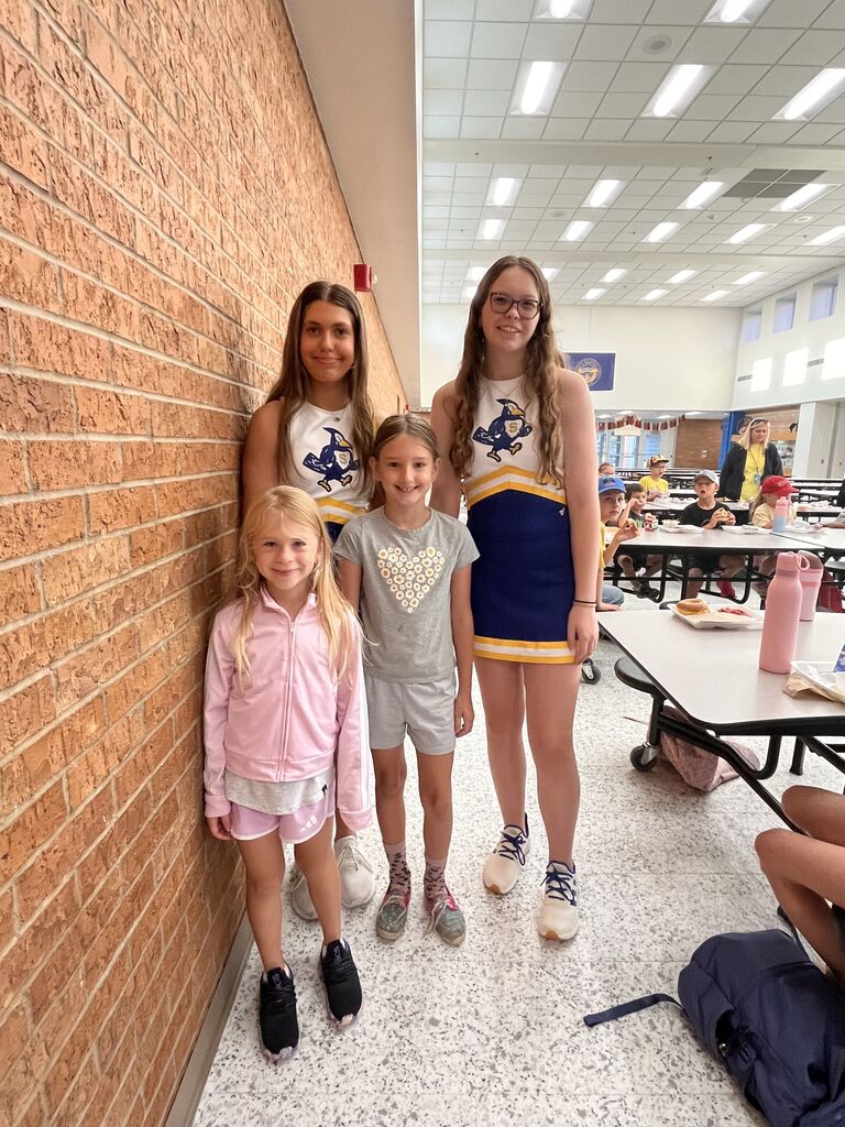 All smiles as cheerleaders post with SES students.