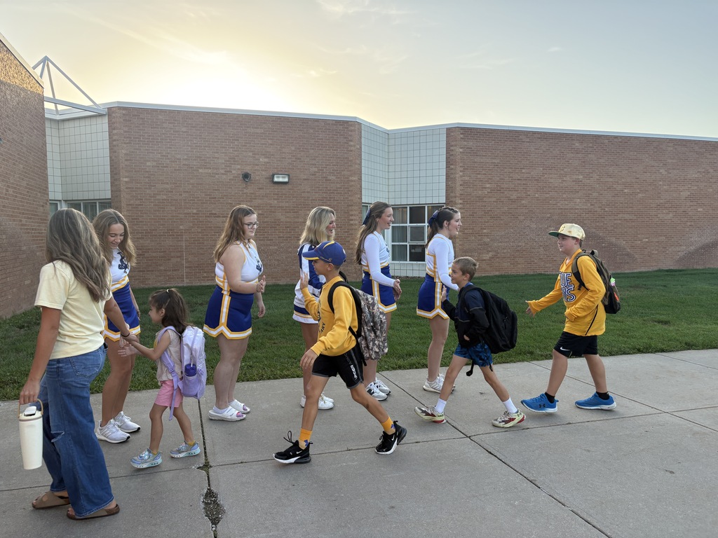 High fives as students enter the building.