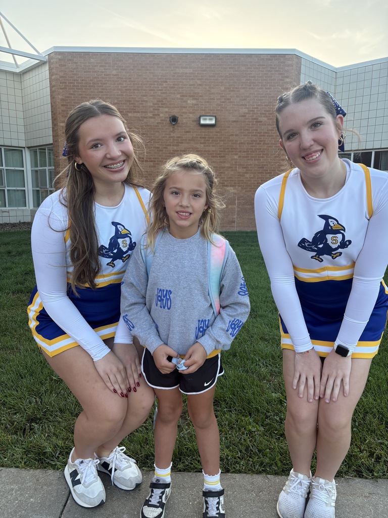 Big smiles as cheerleaders and students start their day.