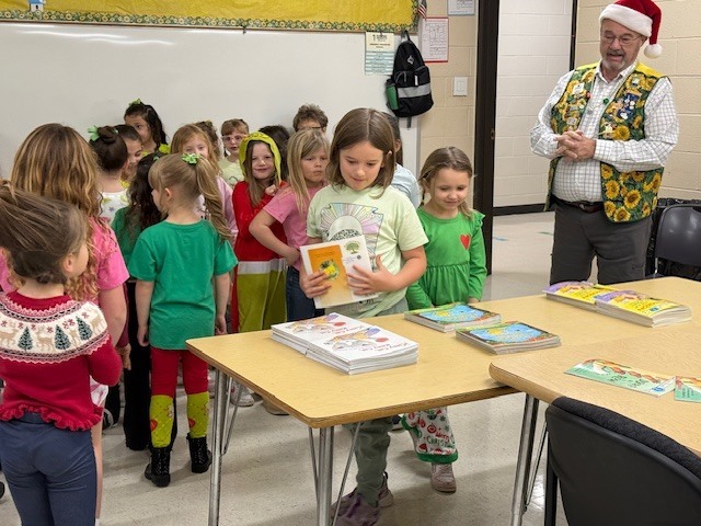 Picture of students picking out which books they would like to take home.