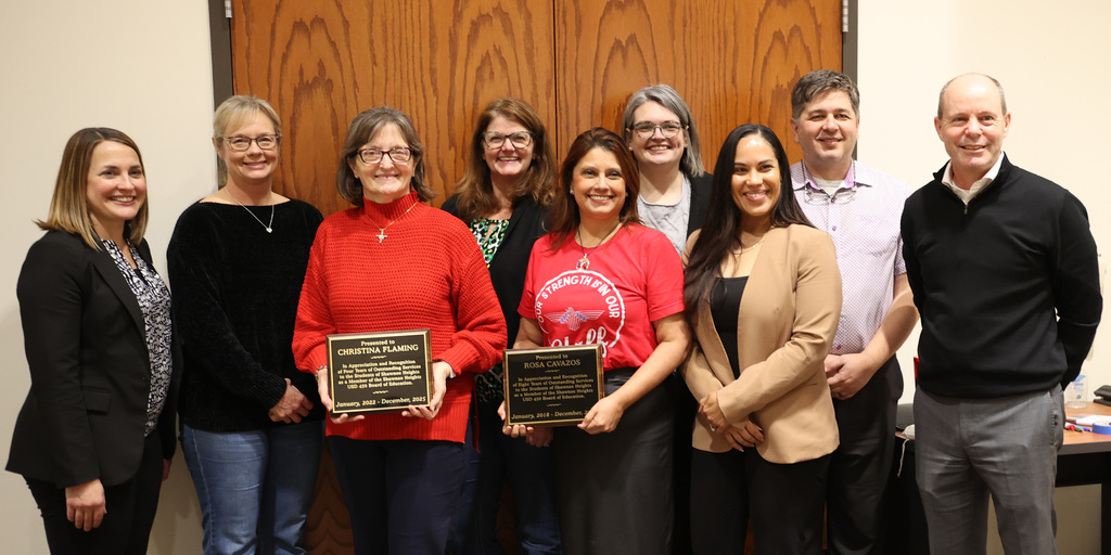 Board of Education Members with Rosa and Christina in the middle holding their appreciation awards.