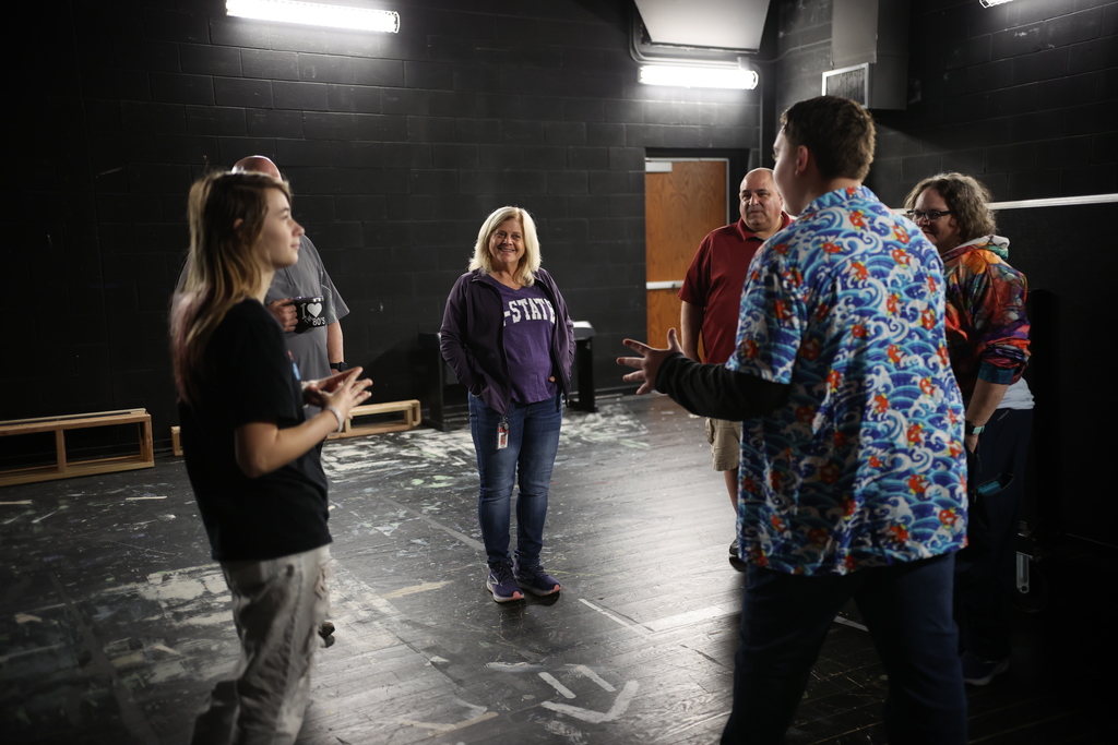 Students lead a small-group activity in the high school theater space, engaging staff in an interactive lesson during a student-led professional development session.