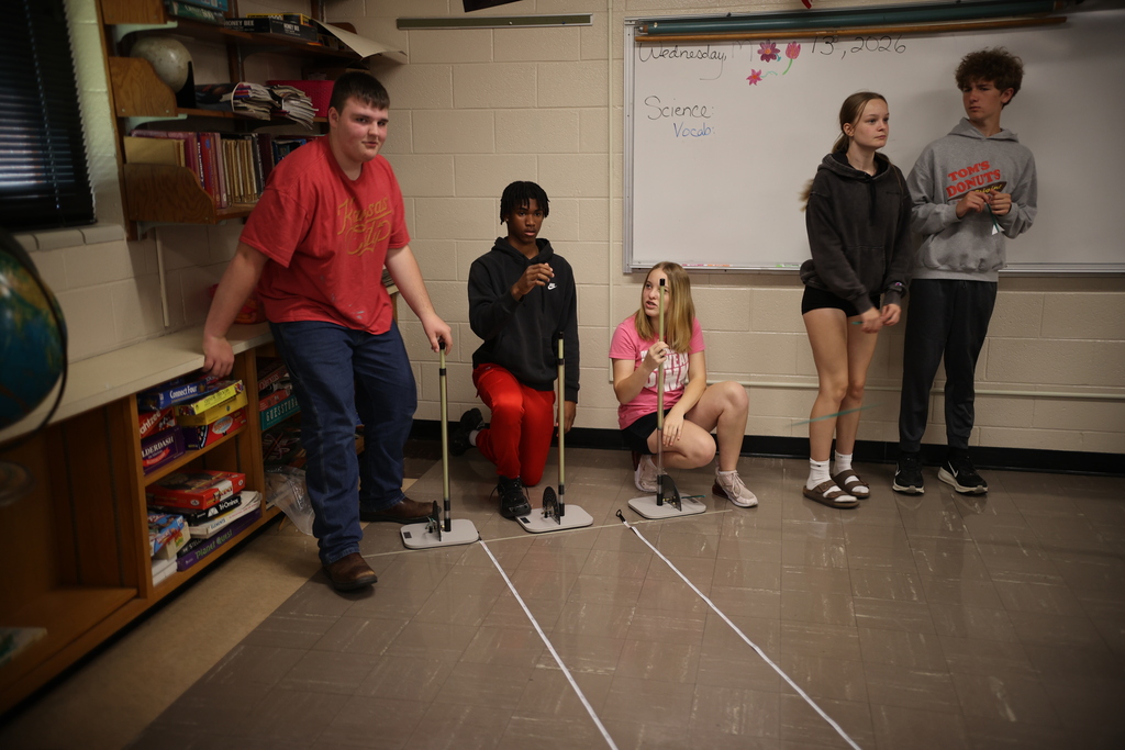Students working on and launching straw rockets.