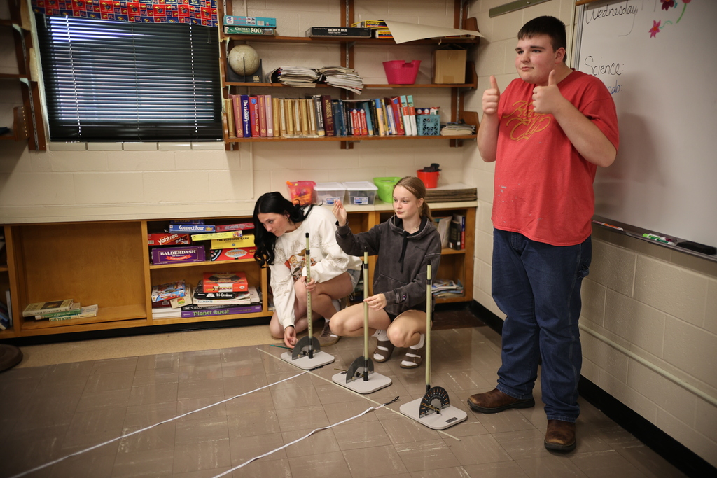 Students working on and launching straw rockets.