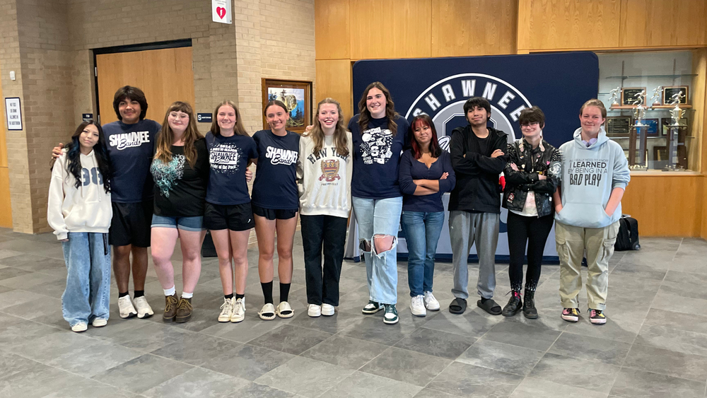 group of students standing in a line smiling