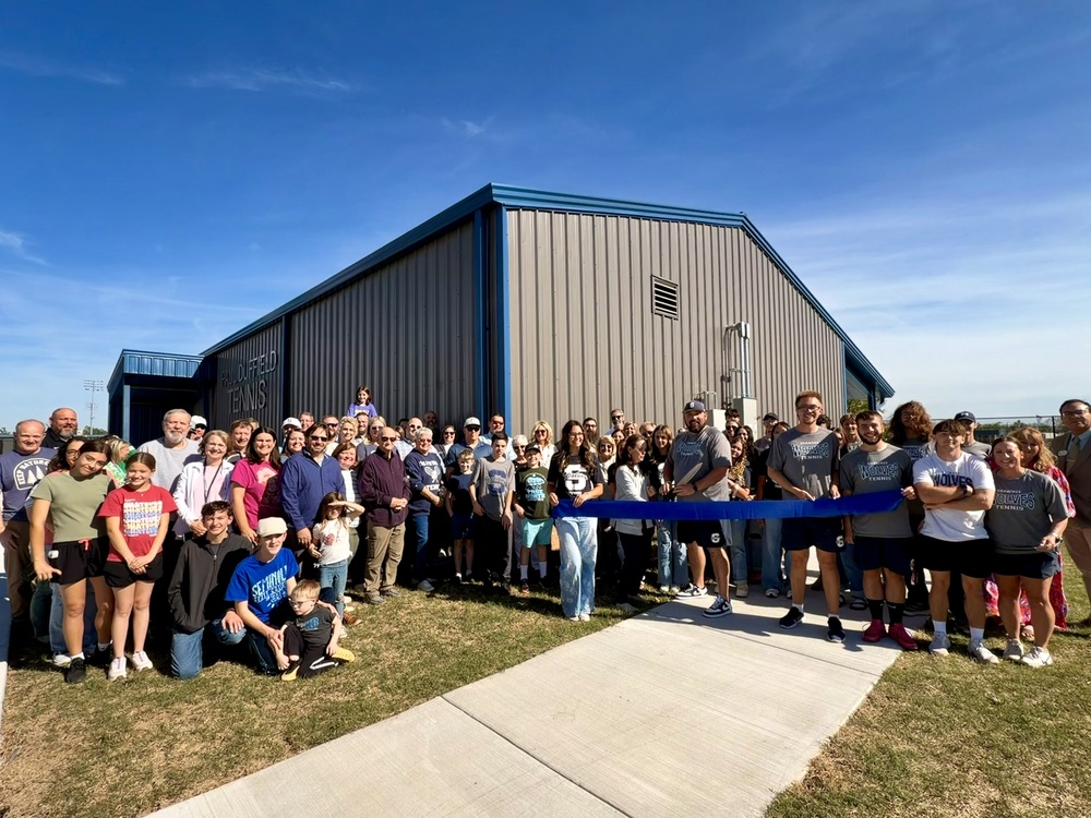large group of people outside for ribbon cutting
