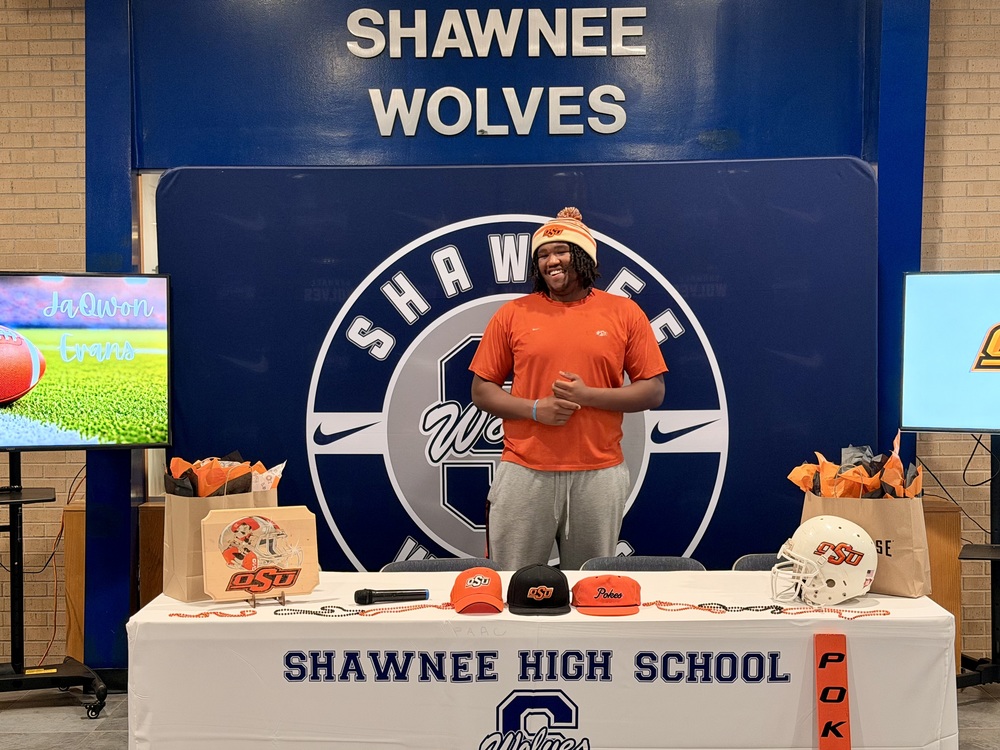 man in orange shirt smiling