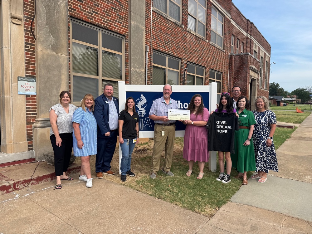 group photo with a large check