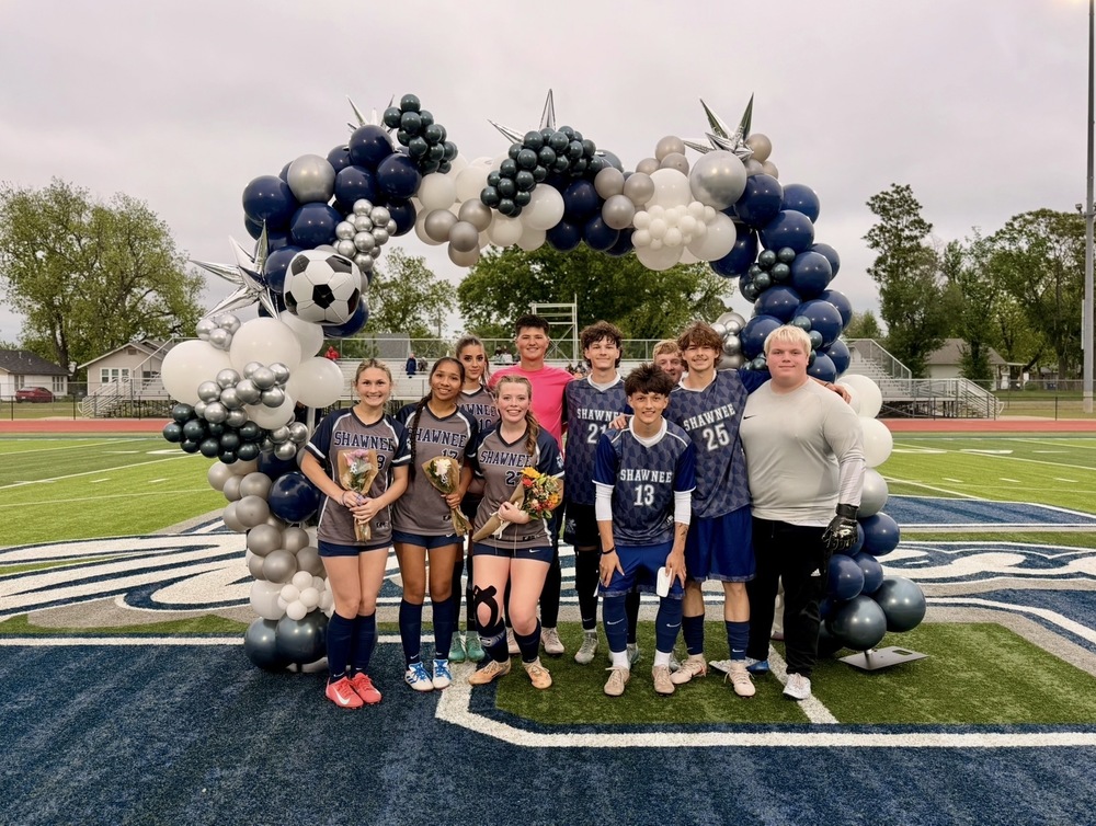 group of soccer players with balloons on field