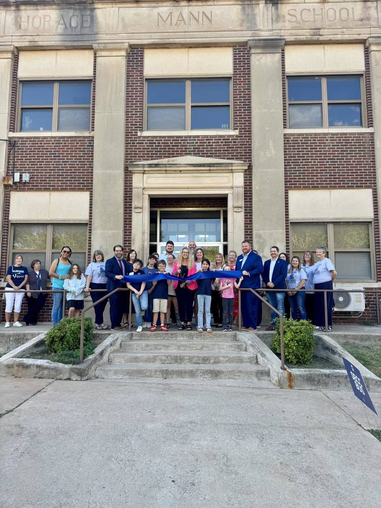 Group of people holding a ribbon