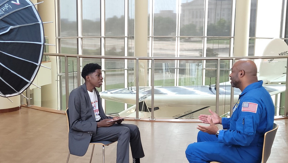 boy interviewing man