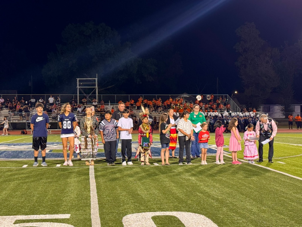 students standing on football field