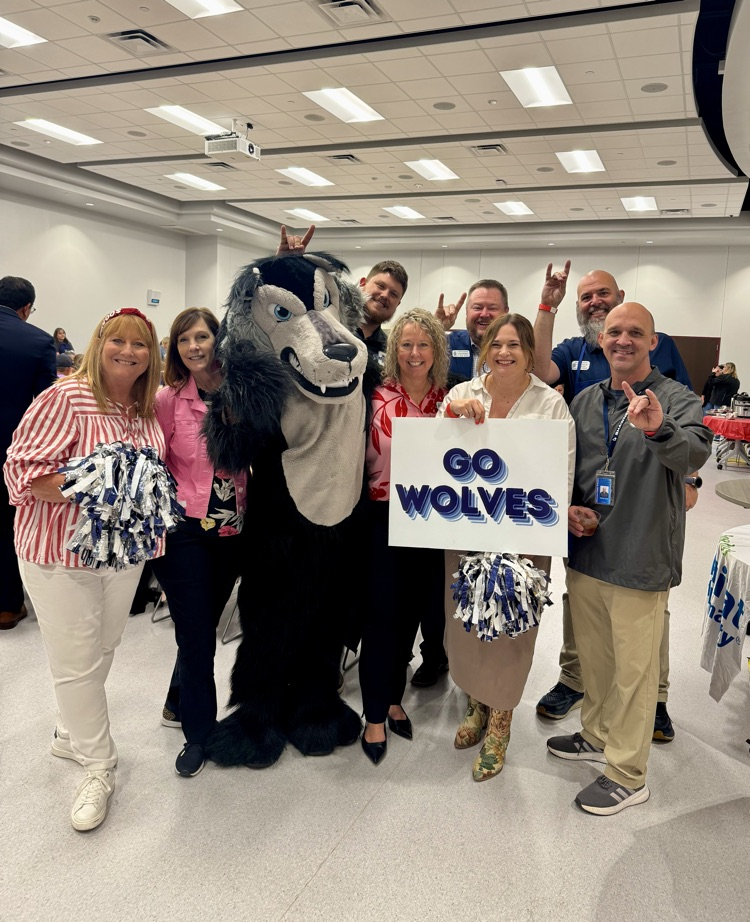 group of adults with wolf mascot