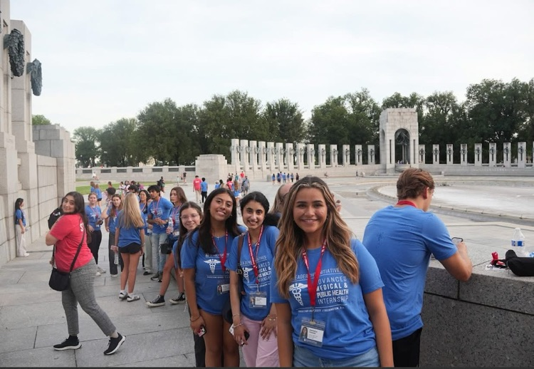 girls standing outside monument
