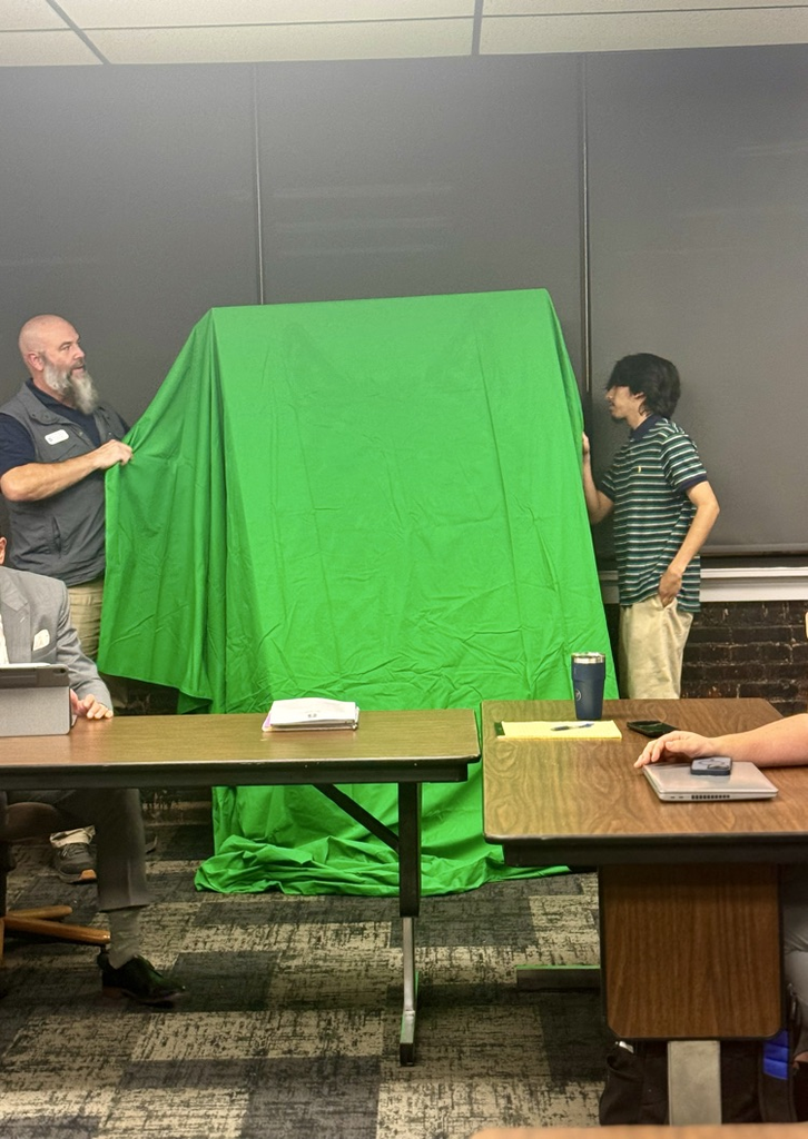 two men unveiling painting