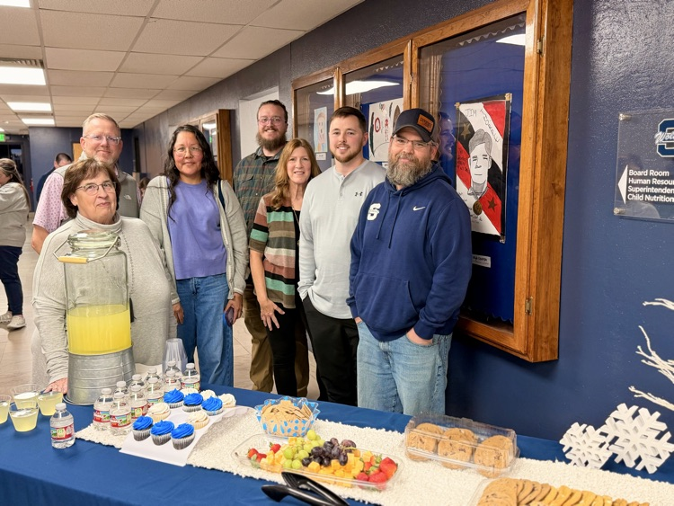 group of adults standing with cookies 