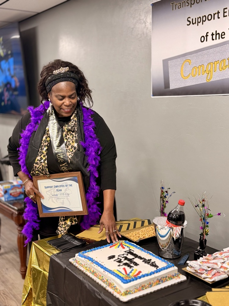 woman wearing tiara with cake and award 
