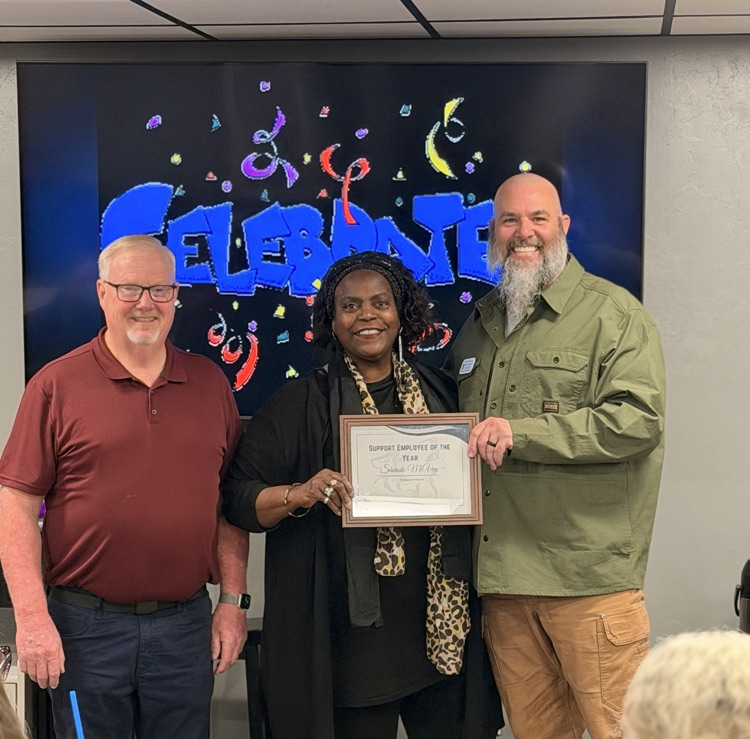 two men and a woman holding award