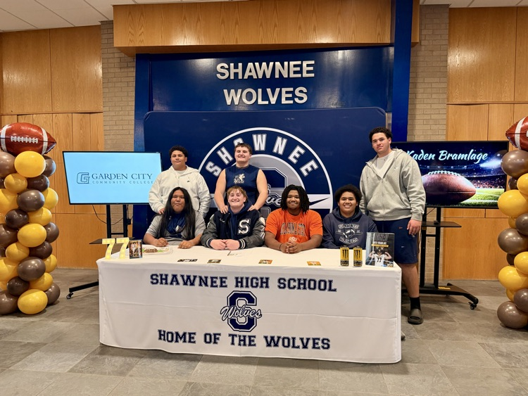group of football players at signing table