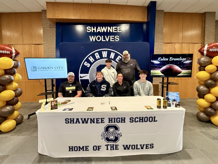family at signing table 