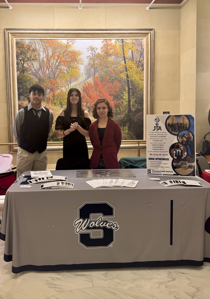 three students at table
