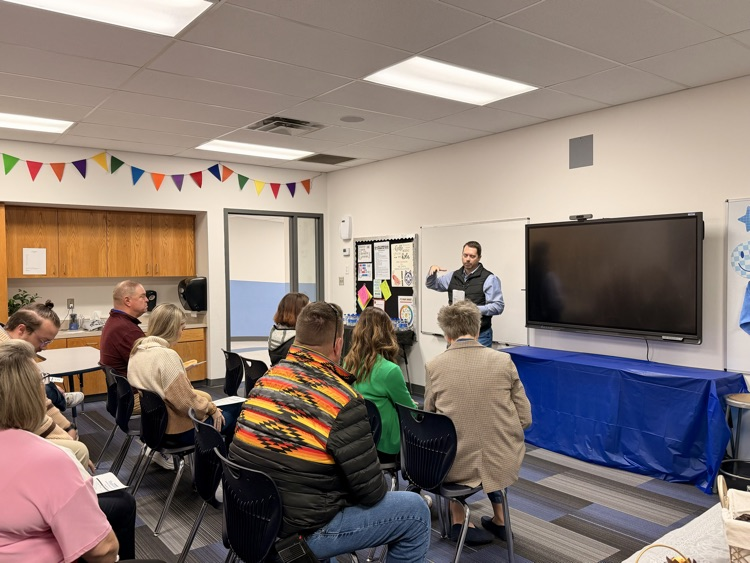 man talking in classroom to adults