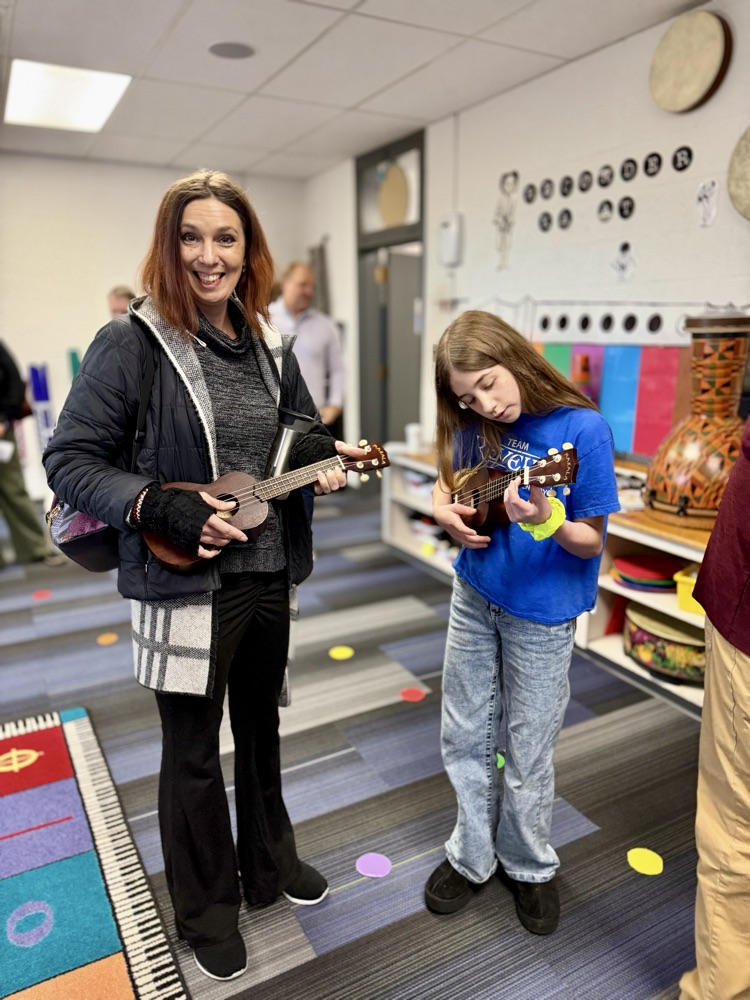 woman with children playing instrument 