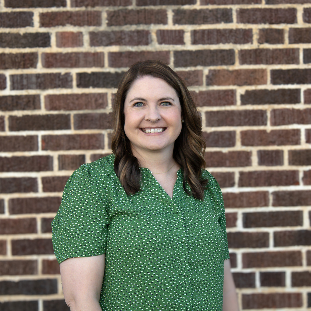 headshot of woman in green shirt