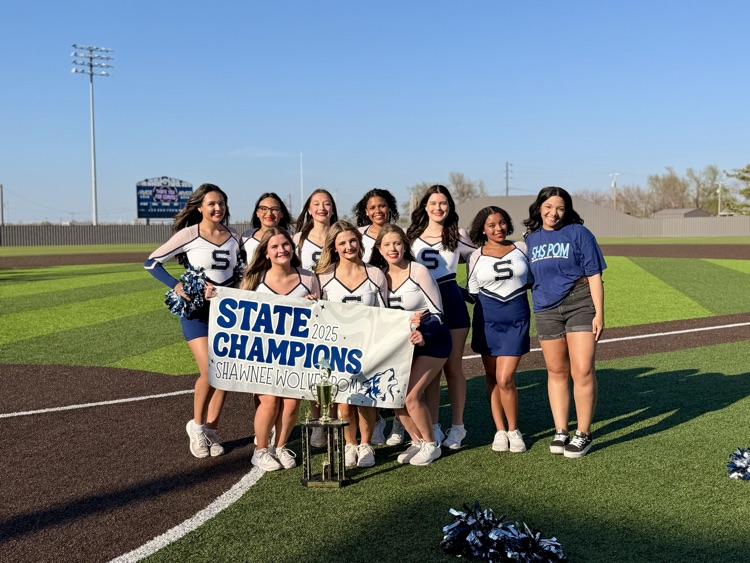 Pom girls holding state champion banner