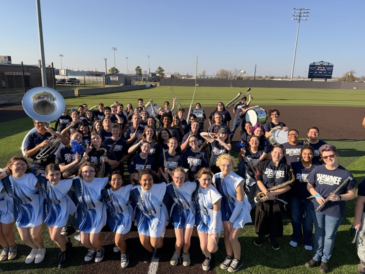 band posing on baseball field