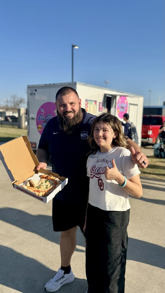 man and daughter holding pizza 