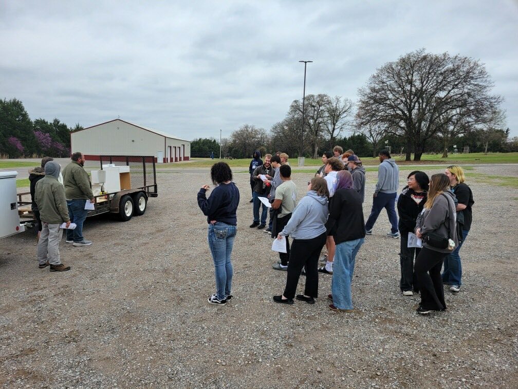 group of students standing outside for plumbing lesson