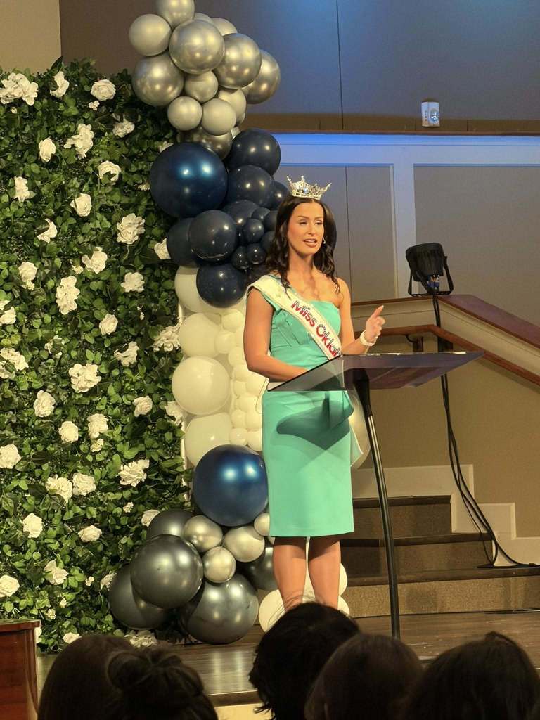 Miss Oklahoma in green dress on stage