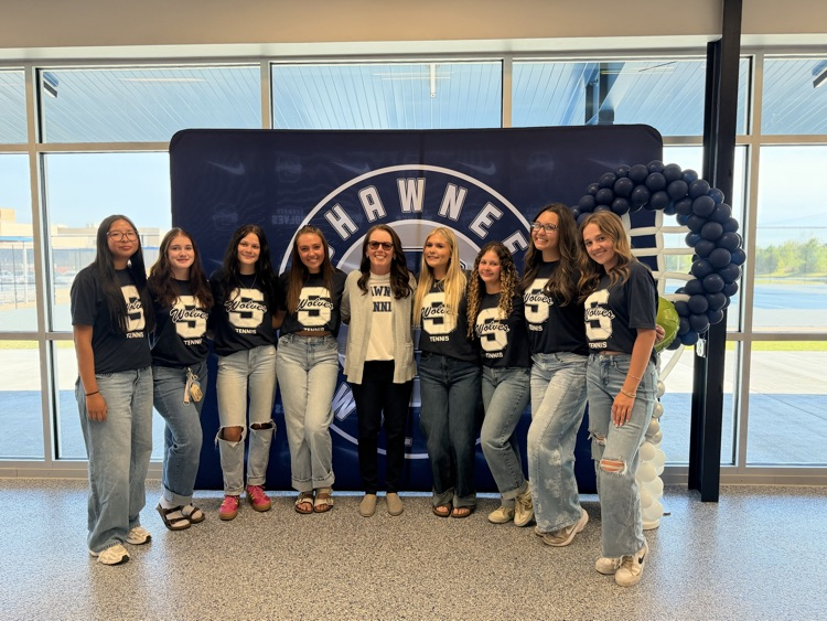 group of teens in front of backdrop 