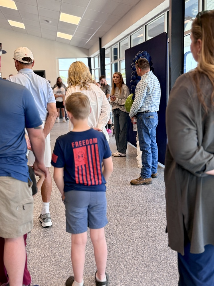 group standing listening to a speaker
