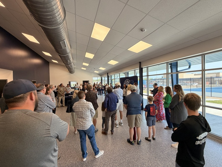 group standing and listening to a speaker