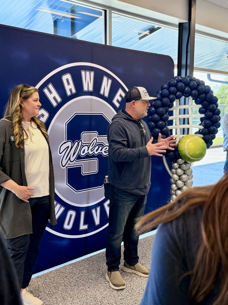 man talking in front of backdrop