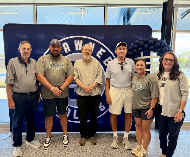 adults in front of backdrop 
