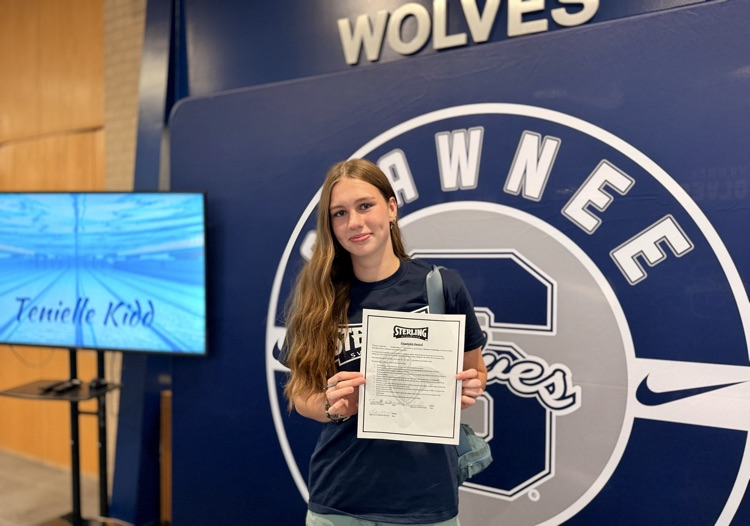 girl holding signed paper 